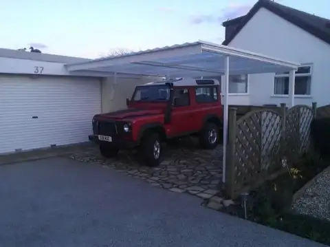 Lean to Carport that covers a 4x4 car