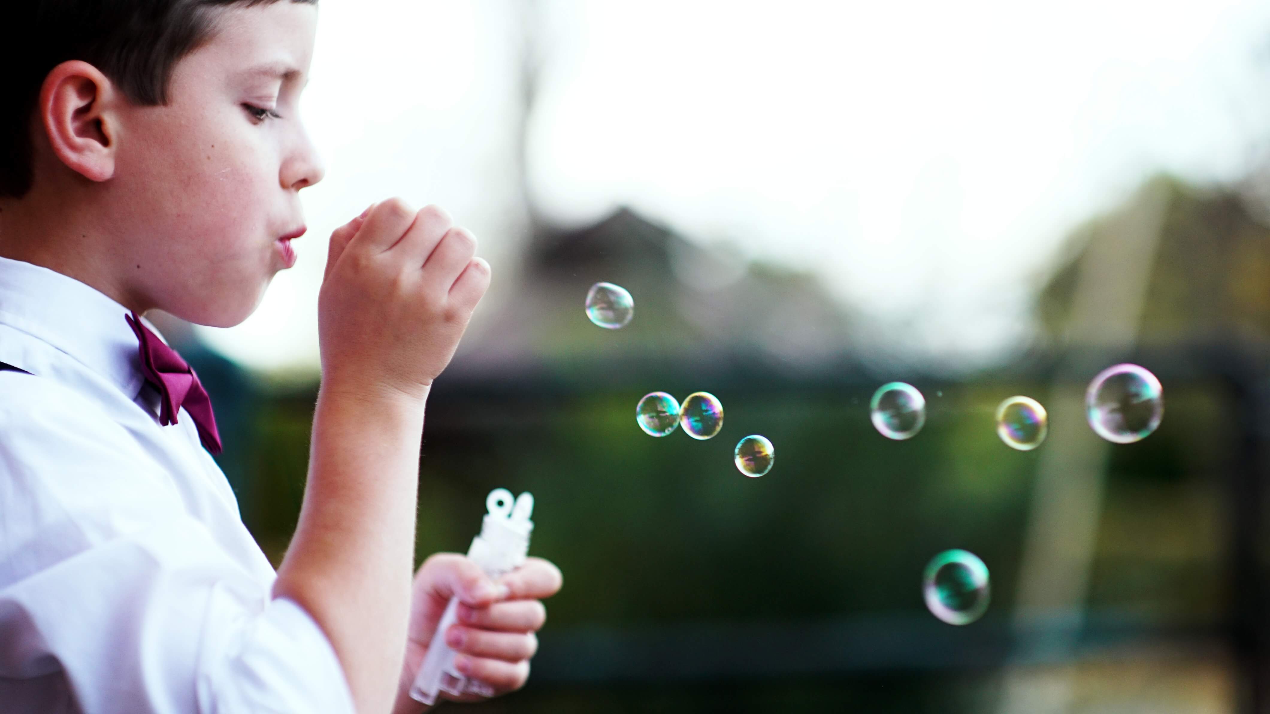 child having fun blowing bubbles